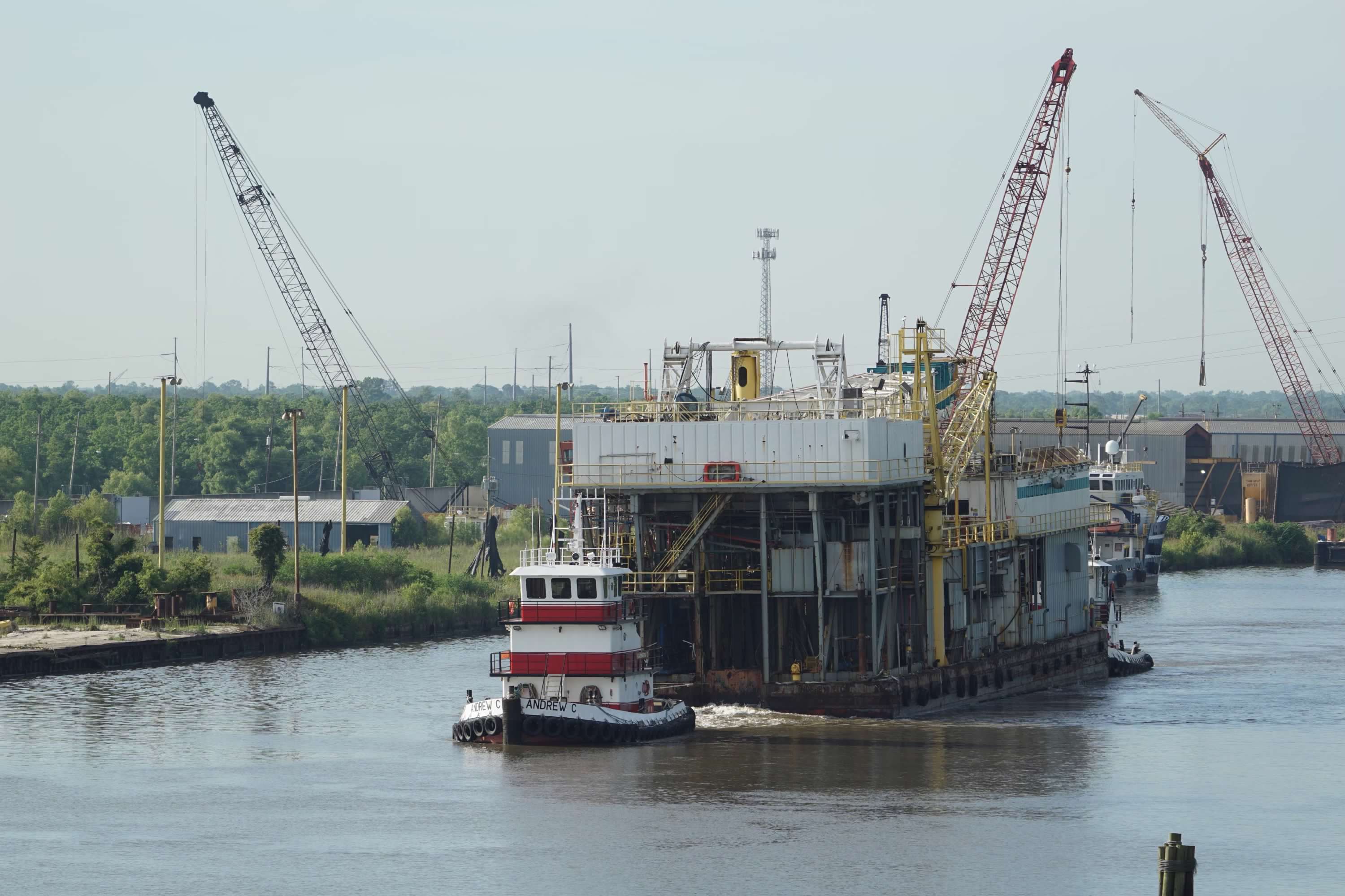 Andrew C pushing offshore platform through Algiers Canal