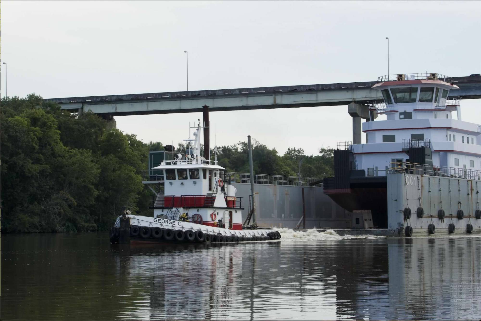 George C pushing barge through canal